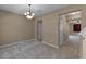 Spacious living room featuring neutral carpet, modern lighting, and an open layout for versatile living at 12335 Cruxbury Dr, Windermere, FL 34786