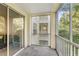 Screened-in balcony with a view of the surrounding greenery and buildings at 12837 Madison Pointe Cir # 206, Orlando, FL 32821