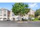Attractive condo building with attached garages and accessible parking spaces at 12837 Madison Pointe Cir # 206, Orlando, FL 32821
