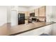 Functional kitchen with black appliances and light wood cabinetry at 12837 Madison Pointe Cir # 206, Orlando, FL 32821