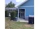 A view of the backyard with a patio, complete with a screened-in pool area and lush greenery at 13111 Sunshine Cir, Clermont, FL 34711