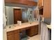 Traditional bathroom featuring a double sink vanity, wooden cabinets, and a large mirror at 13111 Sunshine Cir, Clermont, FL 34711