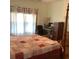 Bedroom with four poster bed, natural light, and a desk area at 13111 Sunshine Cir, Clermont, FL 34711