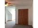 Carpeted bedroom with a ceiling fan, closet, and bright natural light at 13111 Sunshine Cir, Clermont, FL 34711