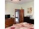 Spacious bedroom with hardwood furniture, a large window, and a doorway to another area of the home at 13111 Sunshine Cir, Clermont, FL 34711