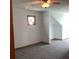 Carpeted bedroom featuring a small window and neutral colored walls at 13111 Sunshine Cir, Clermont, FL 34711