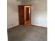 Spacious carpeted bedroom with neutral colors and hardwood doors at 13111 Sunshine Cir, Clermont, FL 34711