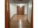 Bright bedroom featuring a spacious closet with wooden doors and hardwood floors at 13111 Sunshine Cir, Clermont, FL 34711