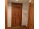 Closet with white shelves and a partially open wooden door with handle at 13111 Sunshine Cir, Clermont, FL 34711