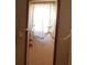 This exterior door is decorated with bright white curtains and features modern handles and locks at 13111 Sunshine Cir, Clermont, FL 34711