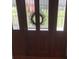 Elegant front door with decorative glass panels and a welcoming wreath at 13111 Sunshine Cir, Clermont, FL 34711