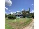 Attractive blue home with dormers, a welcoming front porch, and a nicely landscaped yard at 13111 Sunshine Cir, Clermont, FL 34711