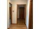 Hallway featuring hardwood flooring and multiple doorways at 13111 Sunshine Cir, Clermont, FL 34711