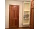 Hallway featuring neutral paint, a door, a closet, and hardwood flooring at 13111 Sunshine Cir, Clermont, FL 34711