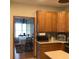 The kitchen features wood cabinets, white countertops, and an open view to the dining room at 13111 Sunshine Cir, Clermont, FL 34711