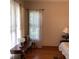 Inviting living room with wood floors, natural light and vintage furniture at 13111 Sunshine Cir, Clermont, FL 34711