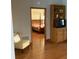Living room showcasing wood floors, built-in shelving, and doorway to the bedroom at 13111 Sunshine Cir, Clermont, FL 34711