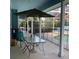 Covered patio area with outdoor furniture, perfect for relaxation and entertainment with a view of the pool at 13111 Sunshine Cir, Clermont, FL 34711
