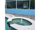 The swimming pool features a built-in jacuzzi with a fountain, along with white coping and blue-tiled trim at 13111 Sunshine Cir, Clermont, FL 34711