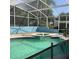 A refreshing pool featuring clear water, a charming fountain, and a screened enclosure for year-round enjoyment at 13111 Sunshine Cir, Clermont, FL 34711
