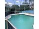 This screened-in swimming pool features turquoise-colored water, white coping, and a safety fence at 13111 Sunshine Cir, Clermont, FL 34711