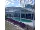 The screened-in pool featuring clear water and landscaped edges, offering a serene backyard oasis at 13111 Sunshine Cir, Clermont, FL 34711
