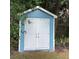 Storage shed with double doors, offering convenient space for tools and equipment at 13111 Sunshine Cir, Clermont, FL 34711