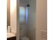 Toilet nook features a toilet with white walls and a hanging light fixture at 13111 Sunshine Cir, Clermont, FL 34711