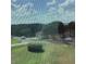 View from window shows a neighborhood with trees, houses and cars at 13111 Sunshine Cir, Clermont, FL 34711