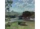 Scenic view of lush landscapes and bright blue skies seen through a screened window at 13111 Sunshine Cir, Clermont, FL 34711