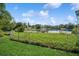 Expansive backyard with a view of the lake, featuring green grass at 1389 Gainesville Ln, Deltona, FL 32725