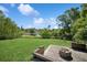 Spacious backyard with lush lawn, leading to scenic lake views and private dock at 1389 Gainesville Ln, Deltona, FL 32725