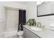 Well-lit bathroom featuring granite countertop and shower with a shower curtain at 1389 Gainesville Ln, Deltona, FL 32725