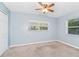 Neutral bedroom with carpet, ceiling fan, and natural light from two windows at 1389 Gainesville Ln, Deltona, FL 32725