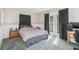 Cozy bedroom featuring a comfortable bed, neutral tones, and natural light through French doors at 1389 Gainesville Ln, Deltona, FL 32725