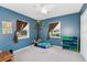 Cozy bedroom with blue walls, carpet flooring and playful tree art at 1389 Gainesville Ln, Deltona, FL 32725