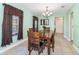A wooden dining room table for six with green walls and a window at 1389 Gainesville Ln, Deltona, FL 32725