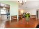 The dining room leads into the kitchen with blue countertops and white cabinets at 1389 Gainesville Ln, Deltona, FL 32725