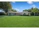 Charming single-story home features a lush lawn, green exterior, and an attached garage at 1389 Gainesville Ln, Deltona, FL 32725