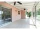 Bright sunroom with tile flooring, ceiling fans, and large sliding glass doors at 1389 Gainesville Ln, Deltona, FL 32725