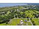Picturesque aerial shot of residences near a tranquil lake, offering a peaceful, nature-filled setting at 1391 Terry Ln, Kissimmee, FL 34744