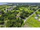 Aerial view showcases lush landscape dotted with trees, and a cozy residence off a quite road at 1391 Terry Ln, Kissimmee, FL 34744