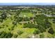 Expansive aerial view of a large property featuring lush greenery, mature trees, and a charming pond at 1391 Terry Ln, Kissimmee, FL 34744