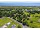 Scenic aerial view of a community near a lake, featuring tree-lined streets and green lawns, ideal for serene living at 1391 Terry Ln, Kissimmee, FL 34744
