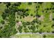 Aerial view of the property showing the expansive land, trees, pond and buildings at 1391 Terry Ln, Kissimmee, FL 34744