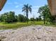 Paver patio overlooking expansive backyard with lush lawn and palm tree at 1391 Terry Ln, Kissimmee, FL 34744