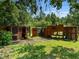 Backyard with enclosed wooden structures for raising chickens at 1391 Terry Ln, Kissimmee, FL 34744
