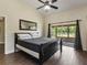 Bedroom with wood floors, natural light, and access to the screened-in patio at 1391 Terry Ln, Kissimmee, FL 34744