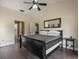 This bedroom features hardwood floors, a ceiling fan, and an en suite bathroom at 1391 Terry Ln, Kissimmee, FL 34744