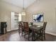 Formal dining room with wood table, tiled floors, modern light fixture, and decorative wall art at 1391 Terry Ln, Kissimmee, FL 34744